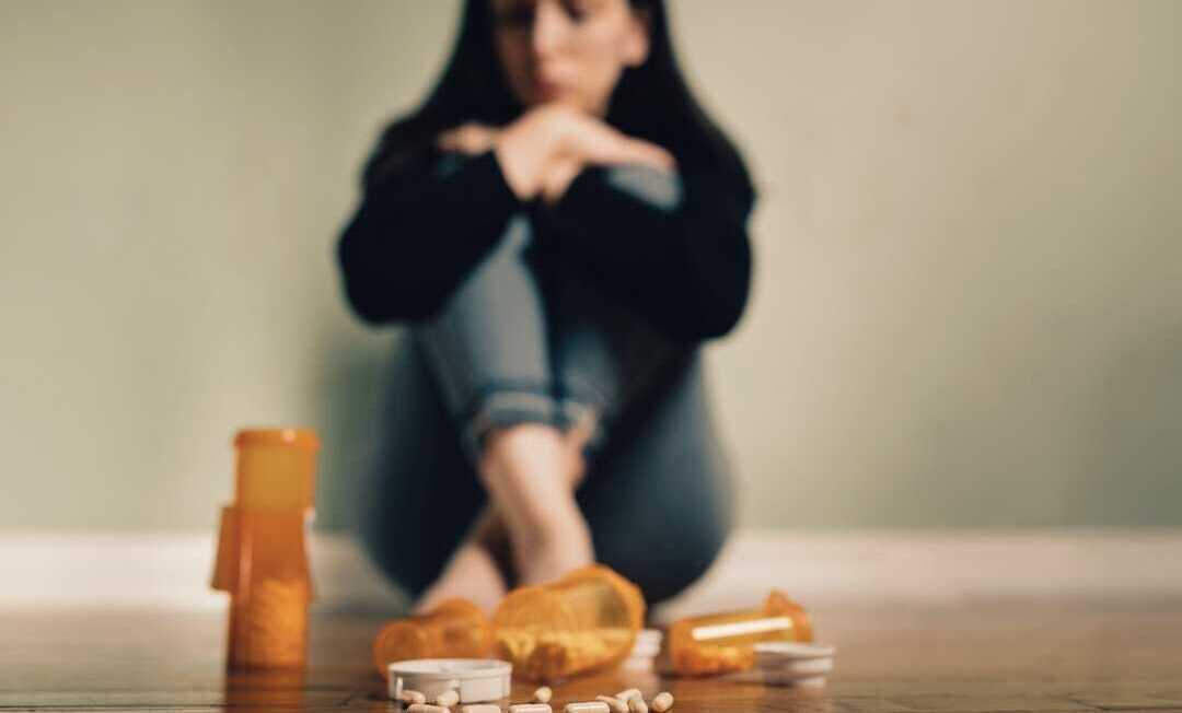 Caucasian female contemplating take prescription pills