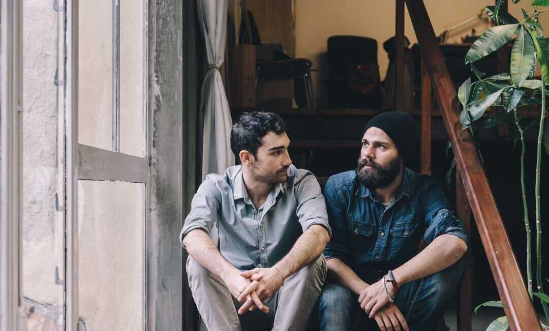 Couple of young men talking on the stairs